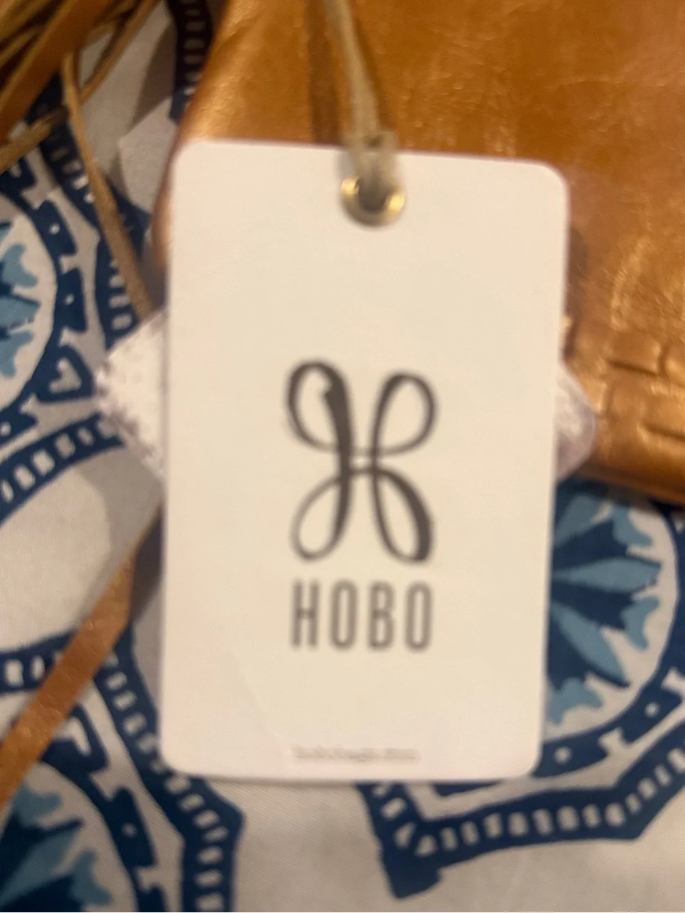 HOBO Metallic Gold Leather Wristlet with Tassel and Ring Handle